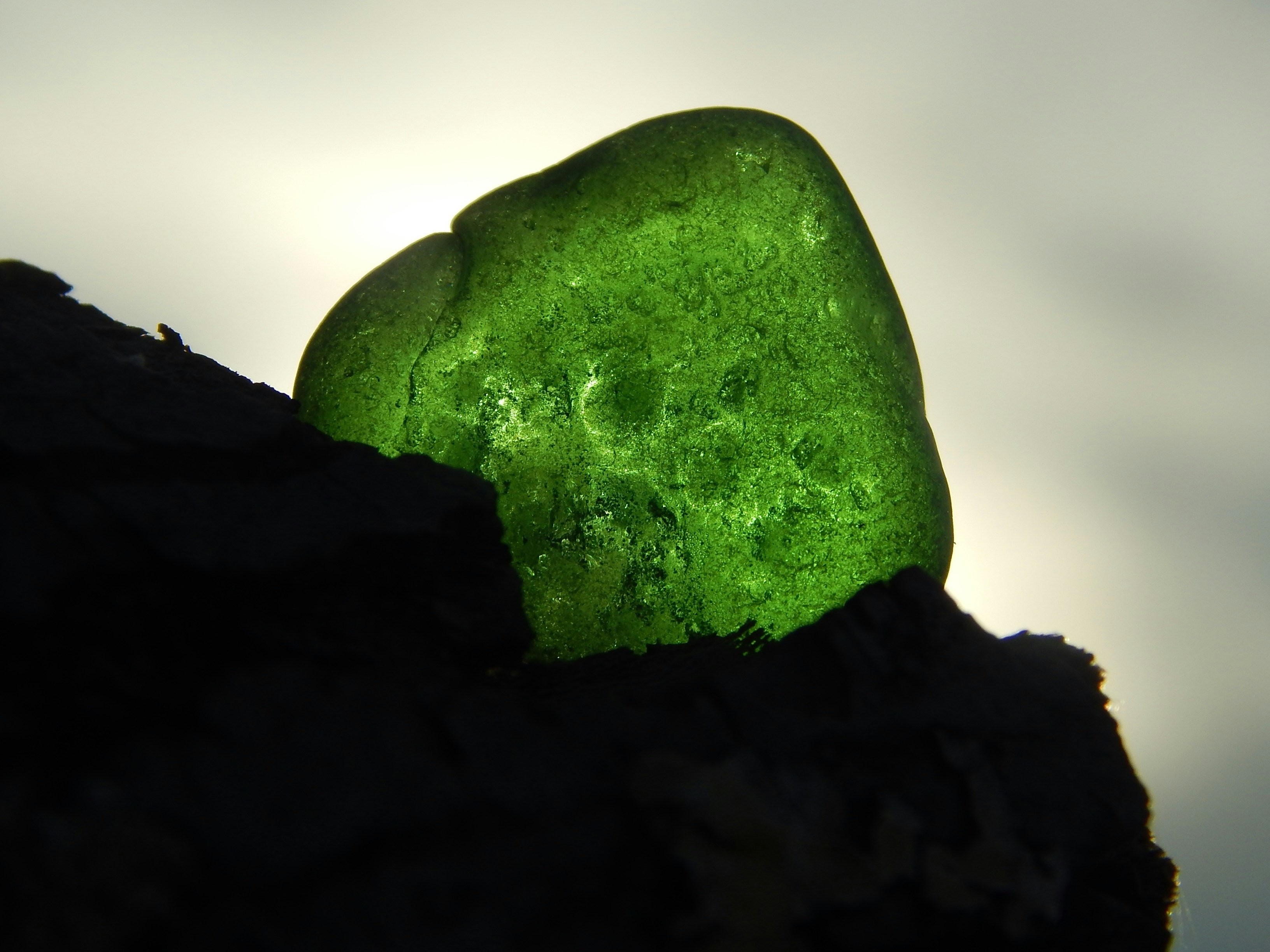 a piece of green sea glass up close