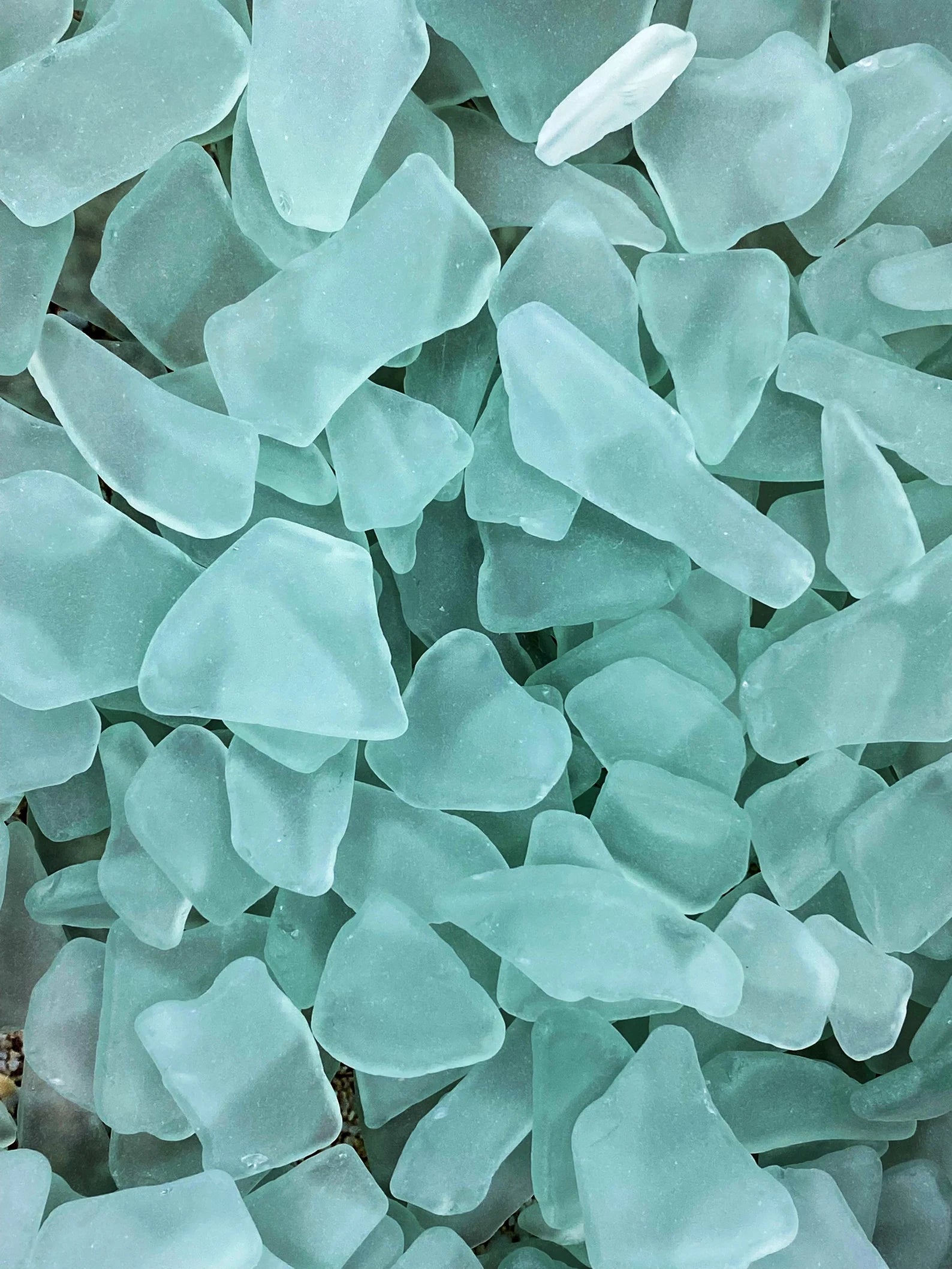 Close-up of green and blue sea glass pieces
